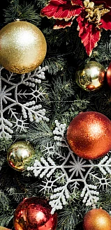 A festive Christmas wreath of pine, red berries, gold and red ornaments, and silver snowflake decorations.